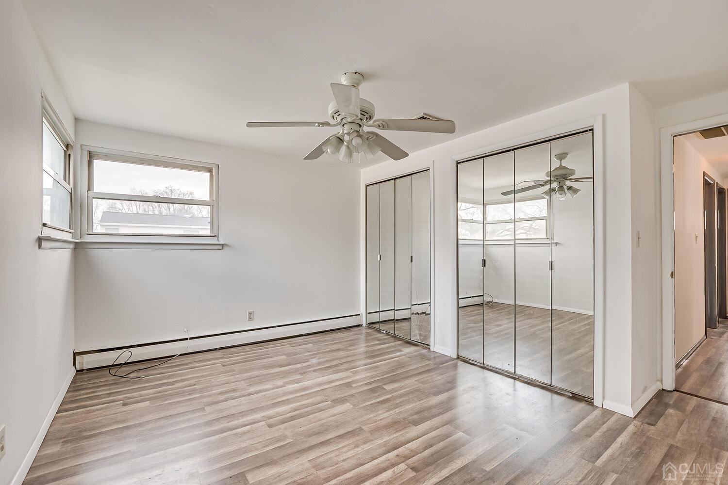 62 Hickory Road Colonia, NJ 07067 - Photo 14 of 23 wooden floor in an empty room with a window