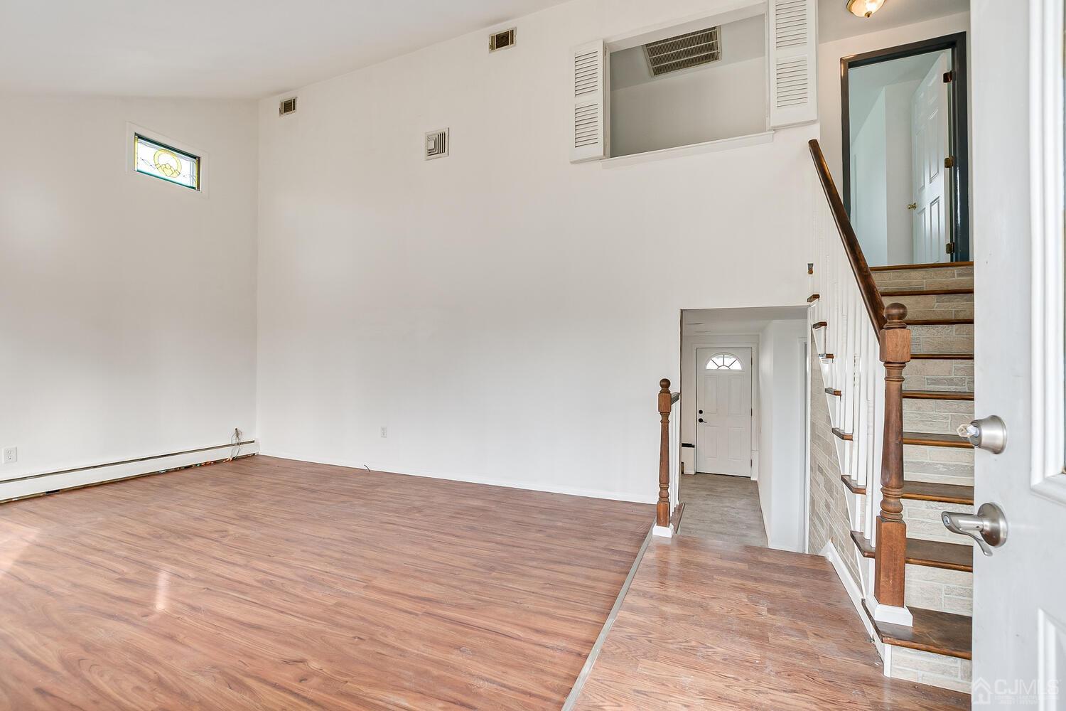 62 Hickory Road Colonia, NJ 07067 - Photo 3 of 23 a view of empty room with wooden floor