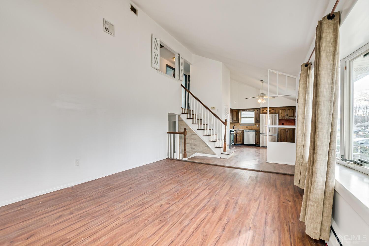 62 Hickory Road Colonia, NJ 07067 - Photo 5 of 23 a view of empty room with wooden floor and fan