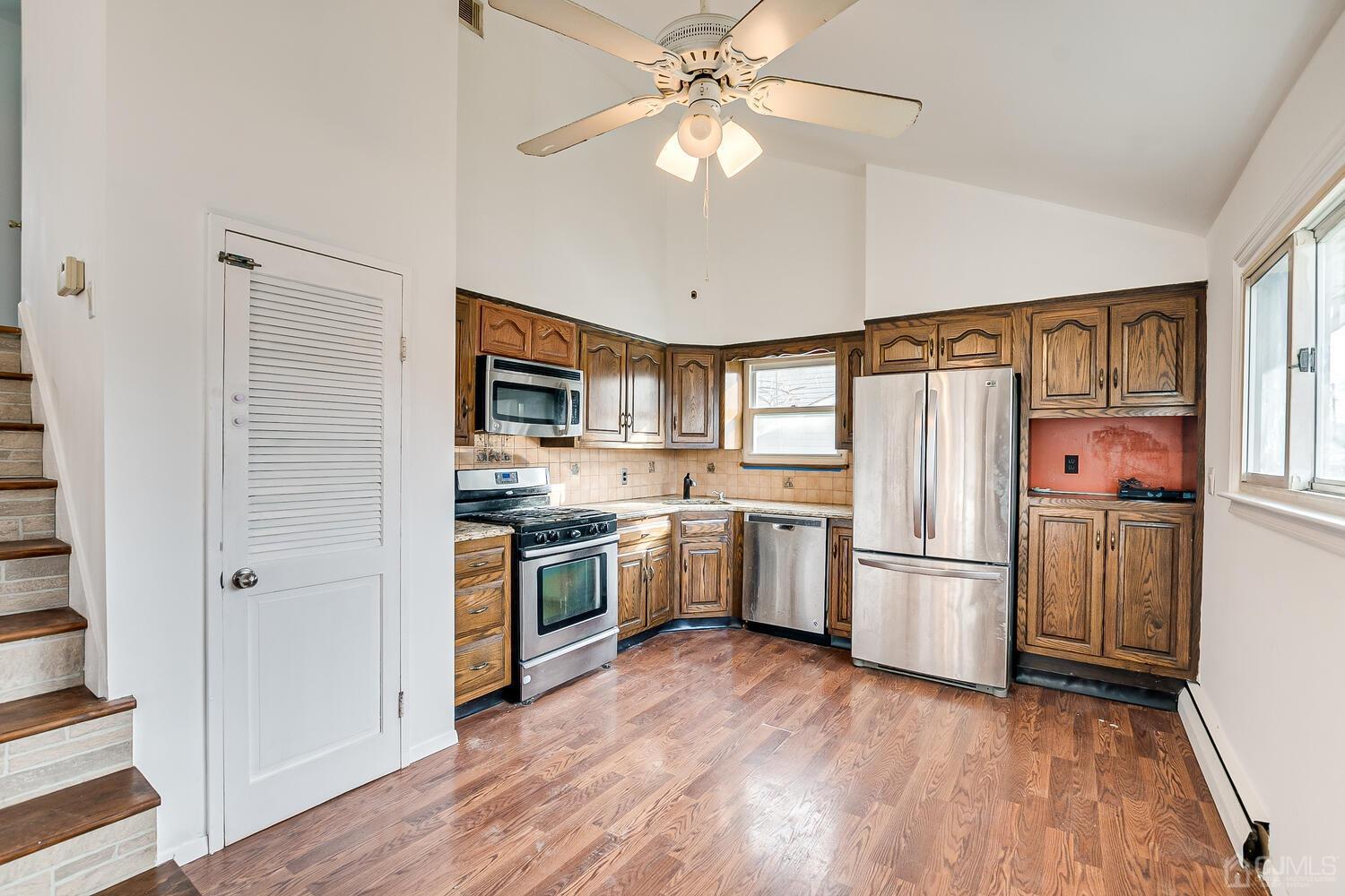 62 Hickory Road Colonia, NJ 07067 - Photo 7 of 23 a kitchen with a refrigerator and a stove top oven