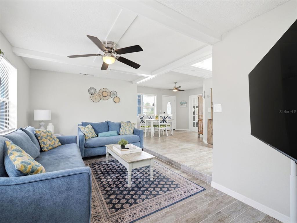 1207 1st Street Indian Rocks Beach, FL 33785 - Photo 10 of 60 a living room with furniture and a flat screen tv