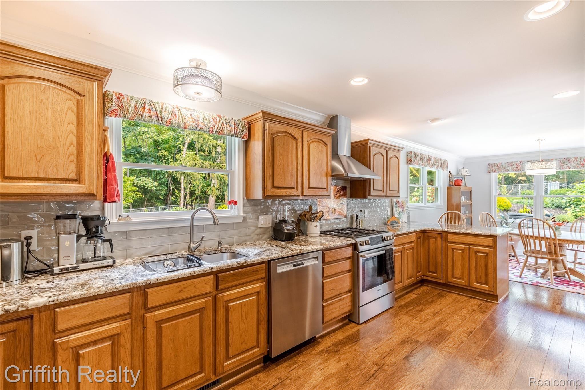 2450 Golf Club Road Howell, MI 48843 - Photo 9 of 59 Chef's delight! High end Thermador appliances include: gas top stove, double ovens , refrigerator-less than 5 years old. Custom back splash, wood floors and an abundance of natural daylight.