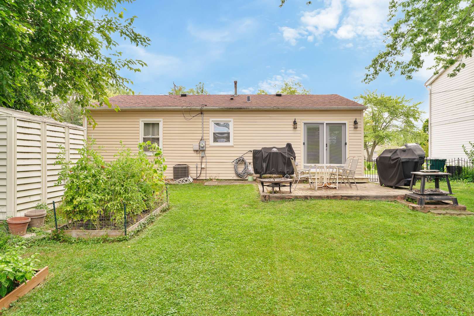 302 South Oltendorf Road Streamwood, IL 60107 - Photo 14 of 19 a view of a house with backyard sitting area and garden