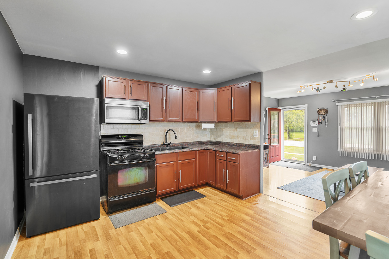 302 South Oltendorf Road Streamwood, IL 60107 - Photo 6 of 19 a kitchen with granite countertop a refrigerator stove top oven and sink