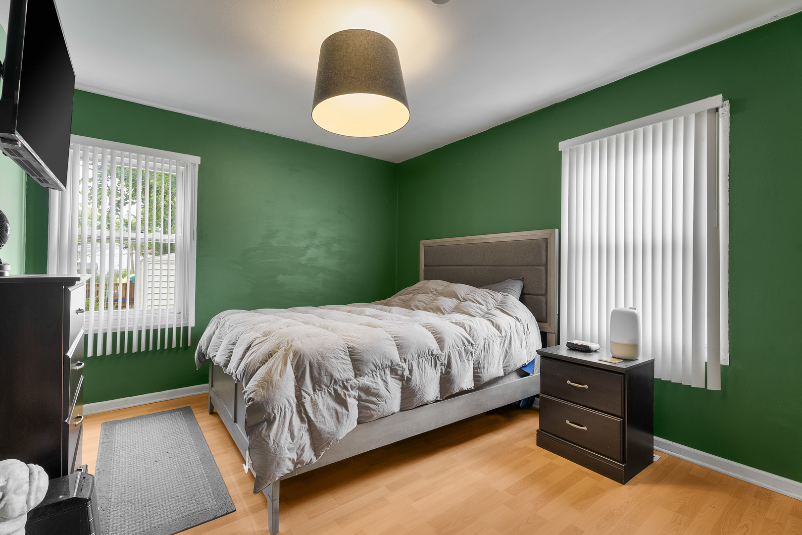 302 South Oltendorf Road Streamwood, IL 60107 - Photo 9 of 19 a bed sitting in a bedroom next to a window