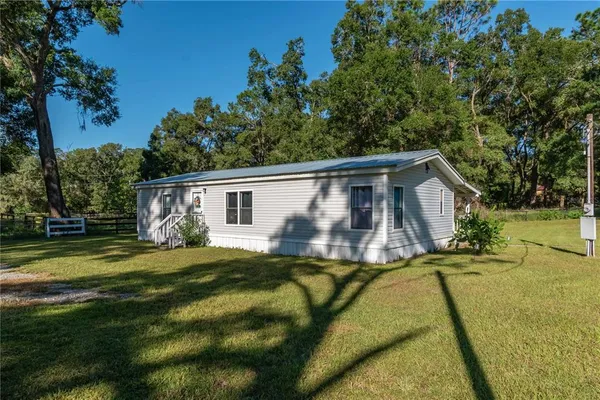 a view of a house with a backyard