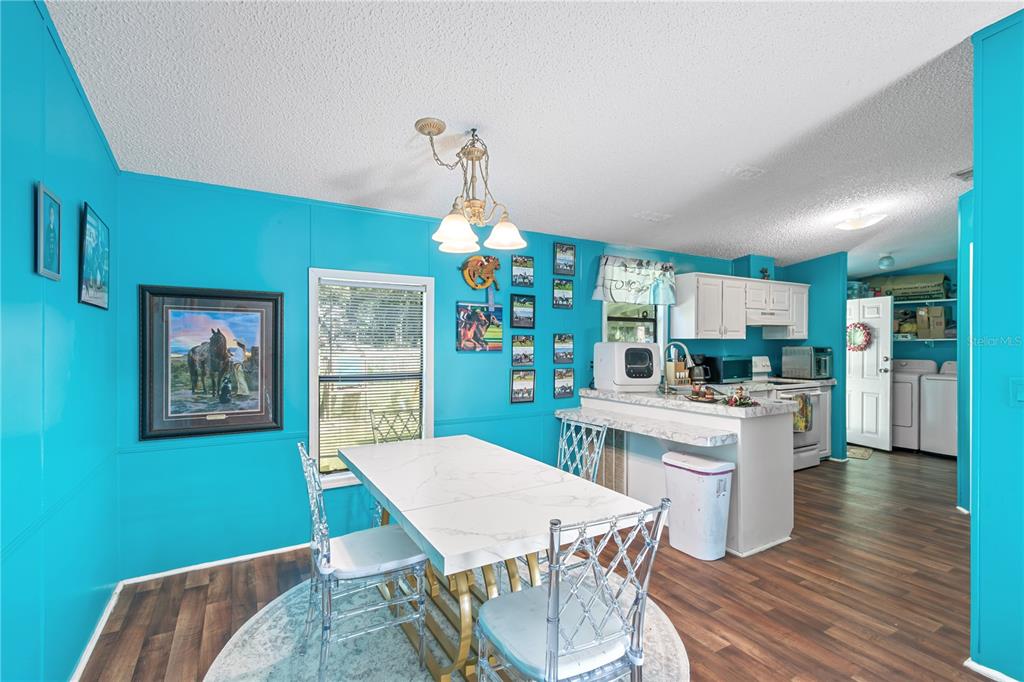 8081 Southwest 41st Place Road Ocala, FL 34481 - Photo 11 of 50 a view of a dining room with furniture window and wooden floor