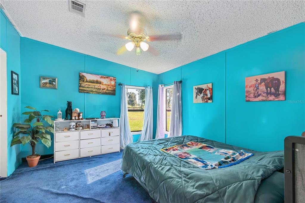 8081 Southwest 41st Place Road Ocala, FL 34481 - Photo 19 of 50 a bedroom with furniture and a chandelier