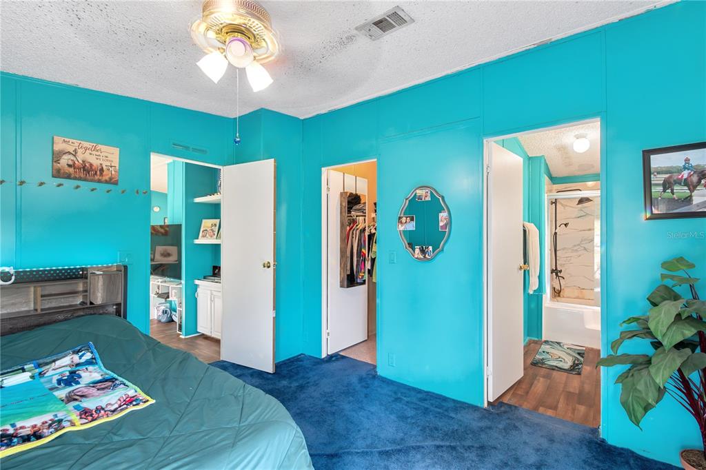 8081 Southwest 41st Place Road Ocala, FL 34481 - Photo 21 of 50 a bed room with a bed and a chandelier