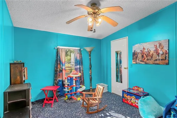 a living room with blue lights with furniture and a large window