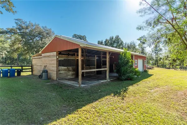 a view of a house with a yard and sitting area