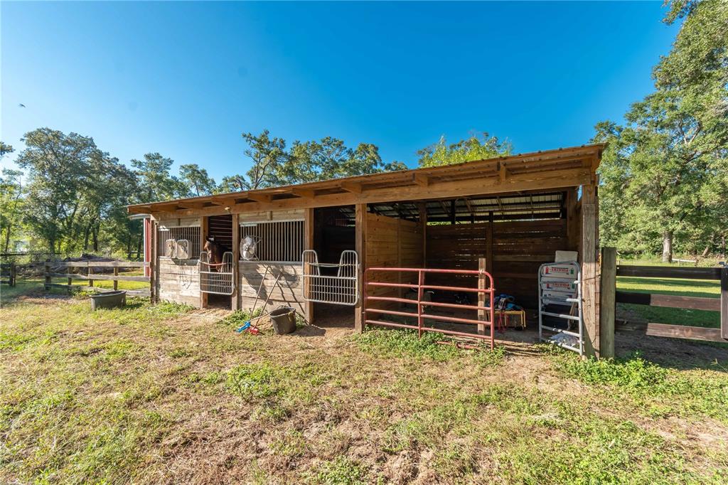 8081 Southwest 41st Place Road Ocala, FL 34481 - Photo 39 of 50 a view of a house with a large window and wooden fence