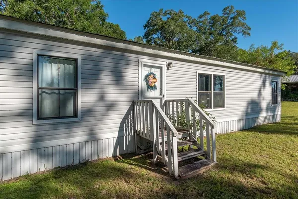 a view of backyard with a deck