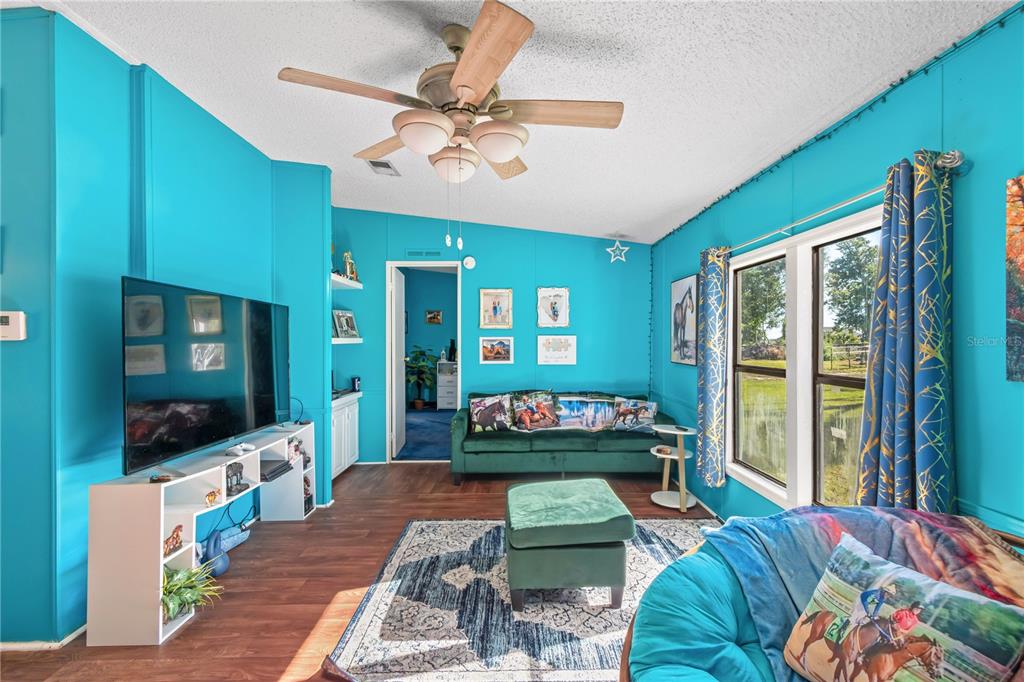 8081 Southwest 41st Place Road Ocala, FL 34481 - Photo 7 of 50 a living room with furniture and a flat screen tv
