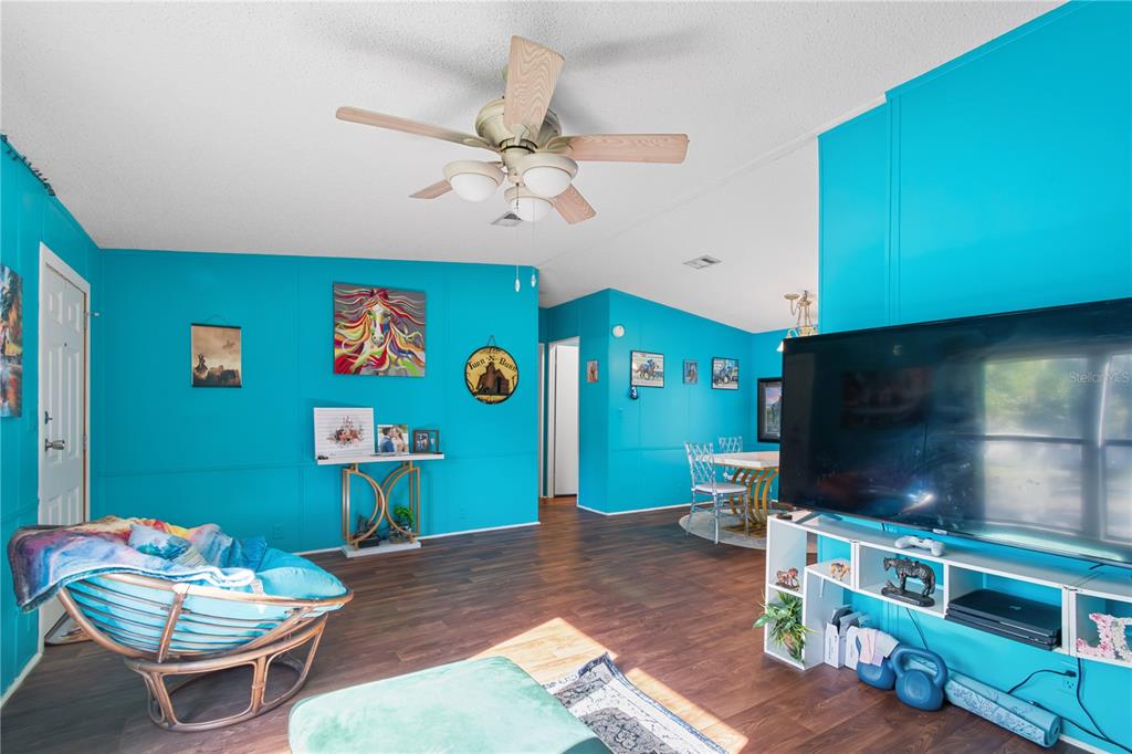 8081 Southwest 41st Place Road Ocala, FL 34481 - Photo 9 of 50 a living room with furniture and a flat screen tv