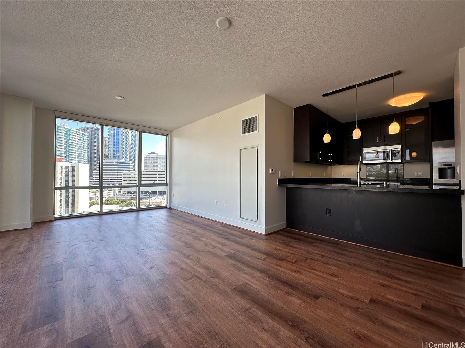 1189 Waimanu Street, Unit 906 Honolulu, HI 96814 - Photo 1 of 1 a view of kitchen with furniture and wooden floor