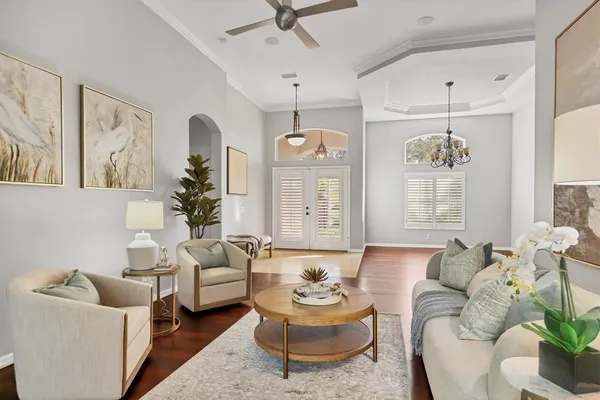 a living room with furniture and a chandelier