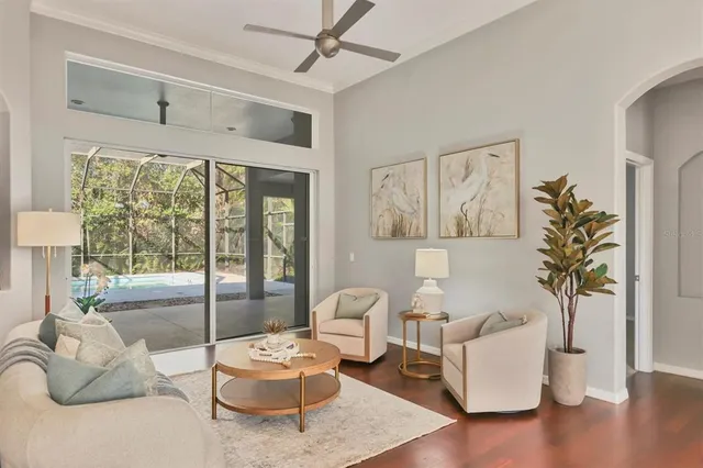 a living room with furniture and wooden floor
