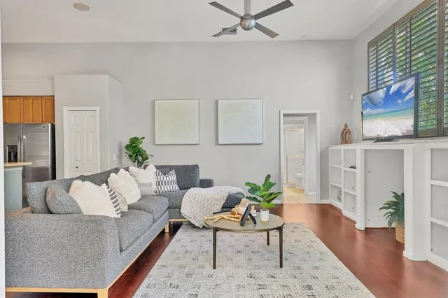 a living room with furniture and wooden floor