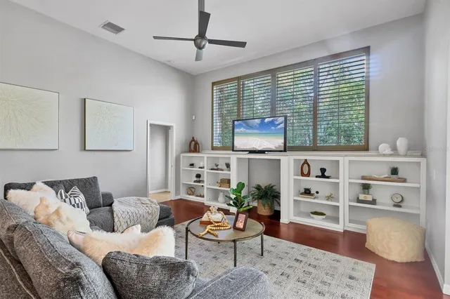 a living room with furniture wooden floor and window