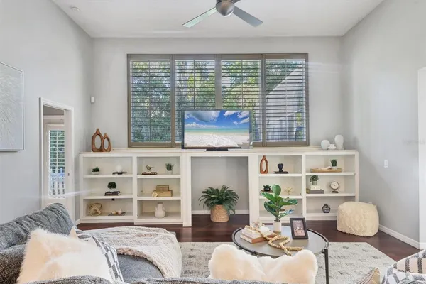 a bedroom with furniture and a large window