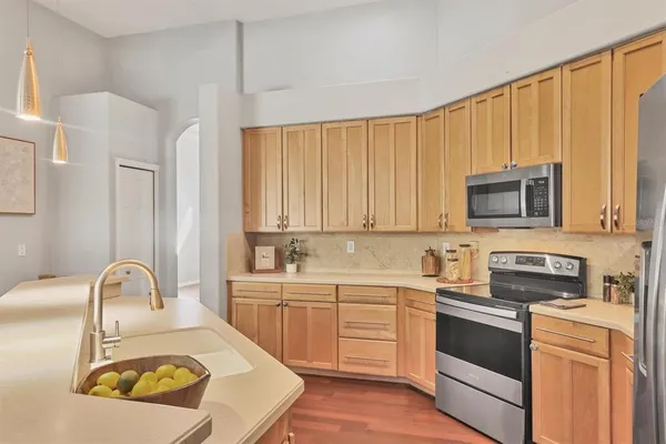 a kitchen with a sink a stove and cabinets
