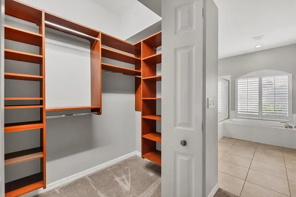 a view of walk in closet with empty racks