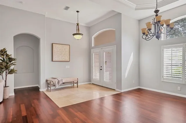 a view of a livingroom with furniture window wooden floor and front door