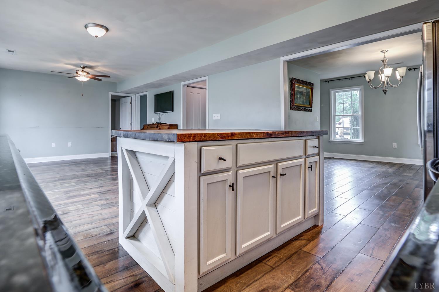 1057 Old Trail Road Forest, VA 24551 - Photo 15 of 49 a view of a livingroom with furniture wooden floor and a ceiling fan