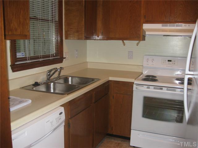 5526 Hamstead Crossing Raleigh, NC 27612 - Photo 4 of 24 a kitchen with a sink stove and cabinets