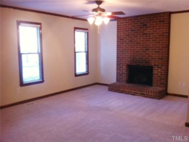 5526 Hamstead Crossing Raleigh, NC 27612 - Photo 8 of 24 an empty room with windows and fireplace