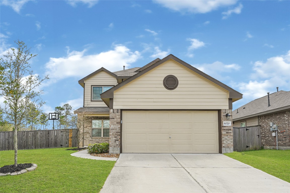 6020 Rimini Landing Lane Porter, TX 77365 - Photo 2 of 33 a front view of house with yard and garage