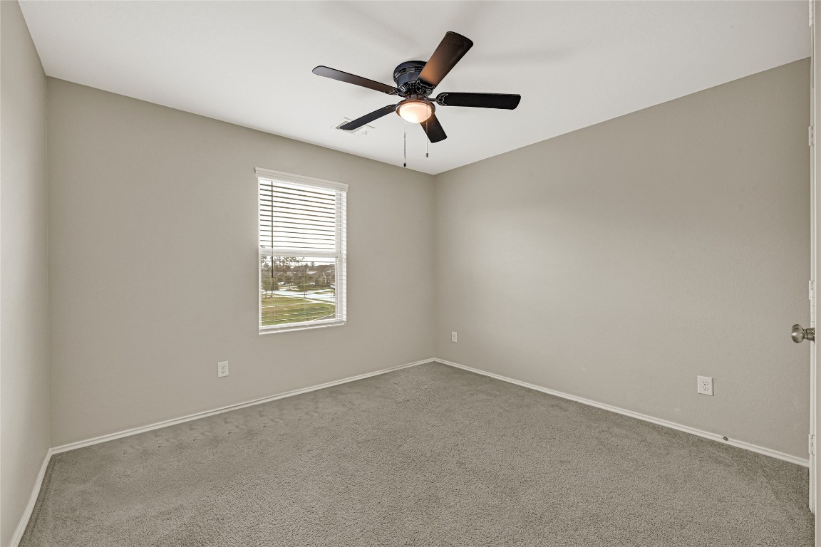 6020 Rimini Landing Lane Porter, TX 77365 - Photo 21 of 33 an empty room with a window and a fan