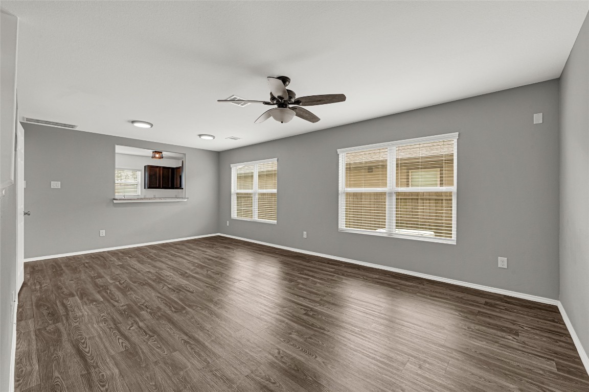 6020 Rimini Landing Lane Porter, TX 77365 - Photo 7 of 33 a view of an empty room with wooden floor and a window