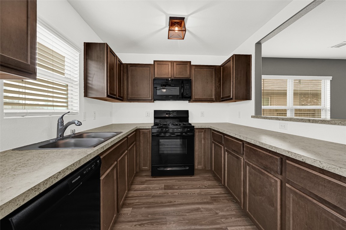 6020 Rimini Landing Lane Porter, TX 77365 - Photo 9 of 33 a kitchen with granite countertop a stove sink and cabinets