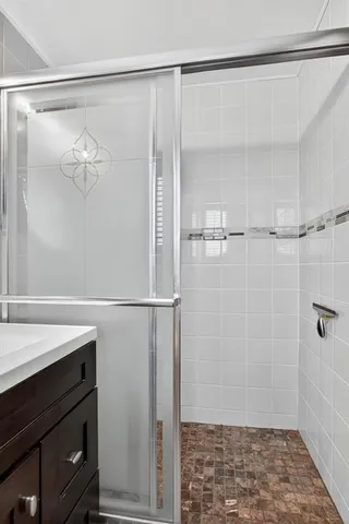 a bathroom with a glass shower door