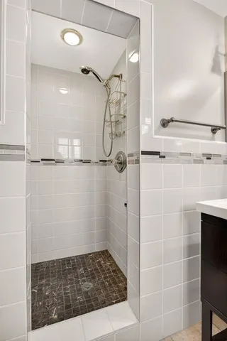 a bathroom with a glass shower door