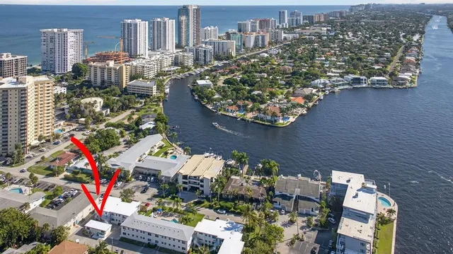 an aerial view of a house with a garden and lake view