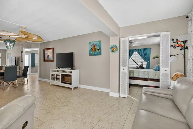 a bedroom with furniture and a flat screen tv
