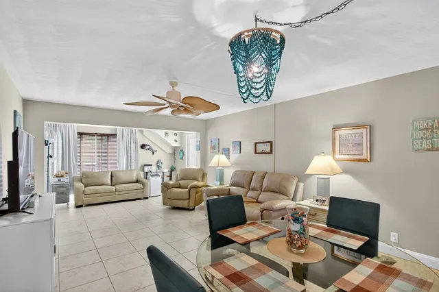 a living room with furniture a rug and a chandelier