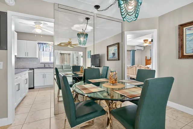a view of a dining room with furniture and chandelier