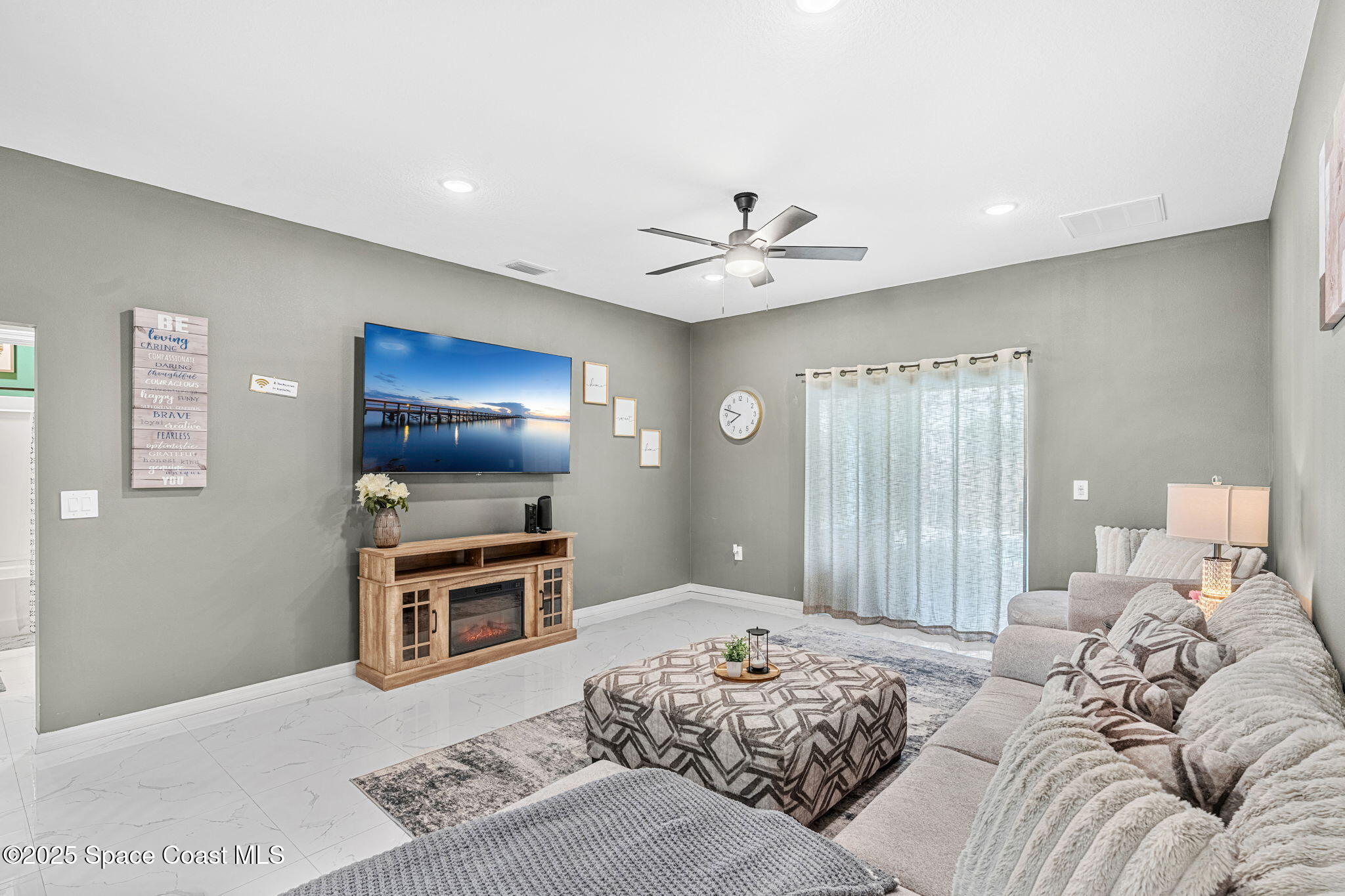 1125 Satin Road Palm Bay, FL 32908 - Photo 11 of 26 a bedroom with a bed and a chandelier