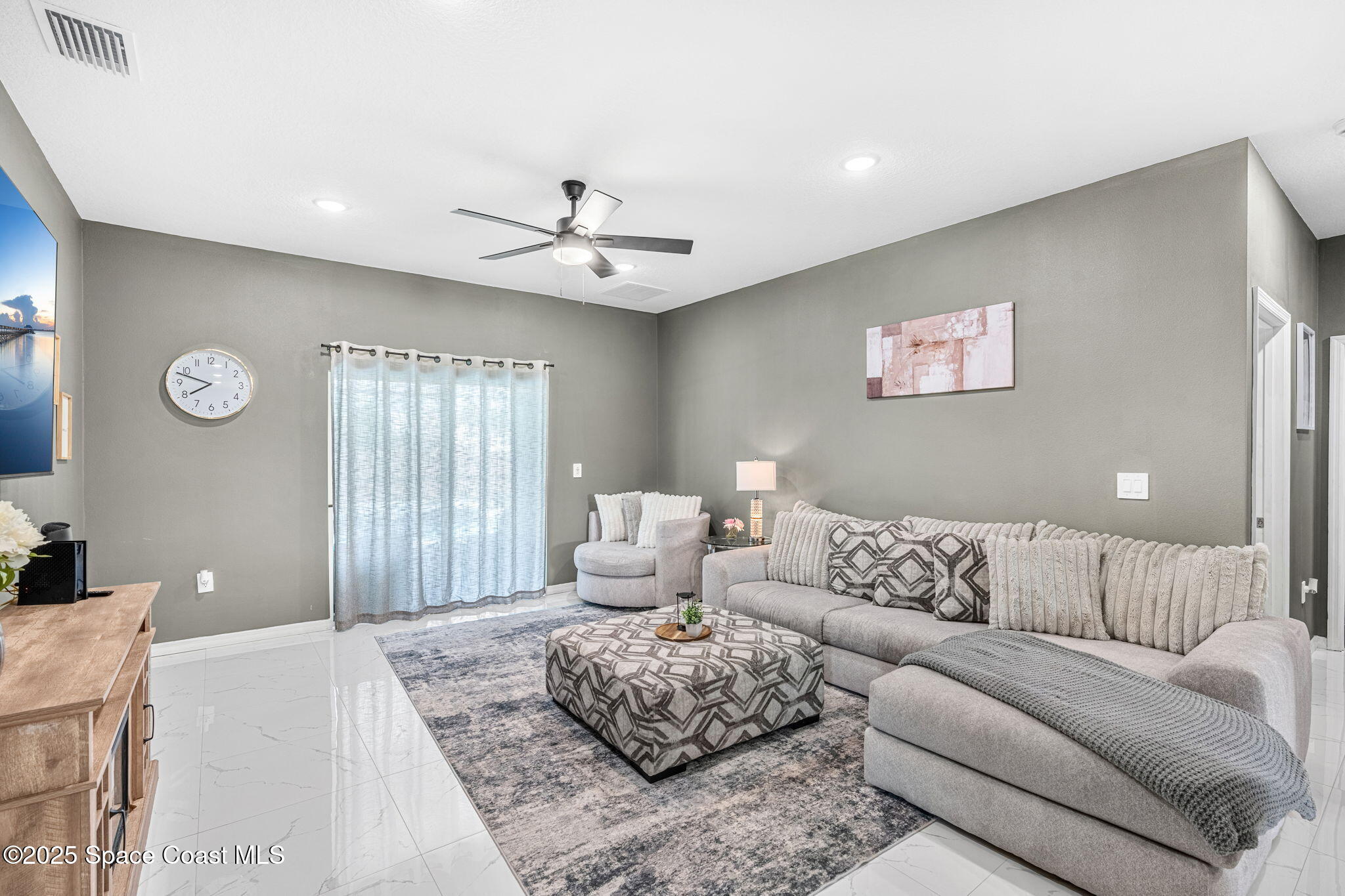 1125 Satin Road Palm Bay, FL 32908 - Photo 12 of 26 a living room with furniture and a large window