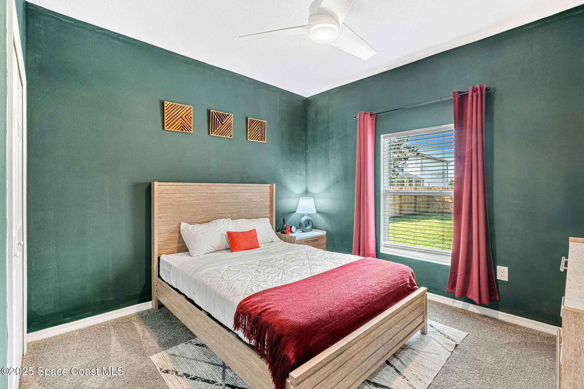 1125 Satin Road Palm Bay, FL 32908 - Photo 16 of 26 a bedroom with a bed and a large window