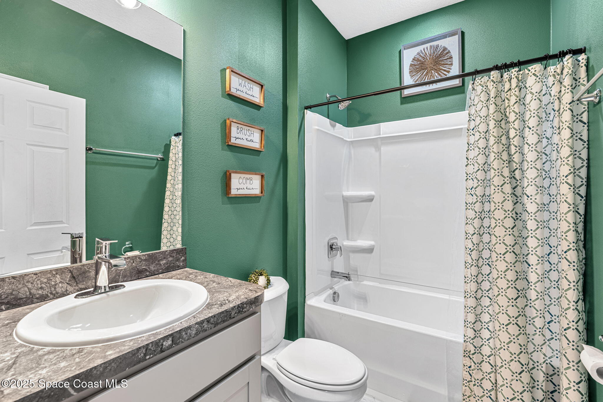 1125 Satin Road Palm Bay, FL 32908 - Photo 17 of 26 a bathroom with a granite countertop sink toilet and shower