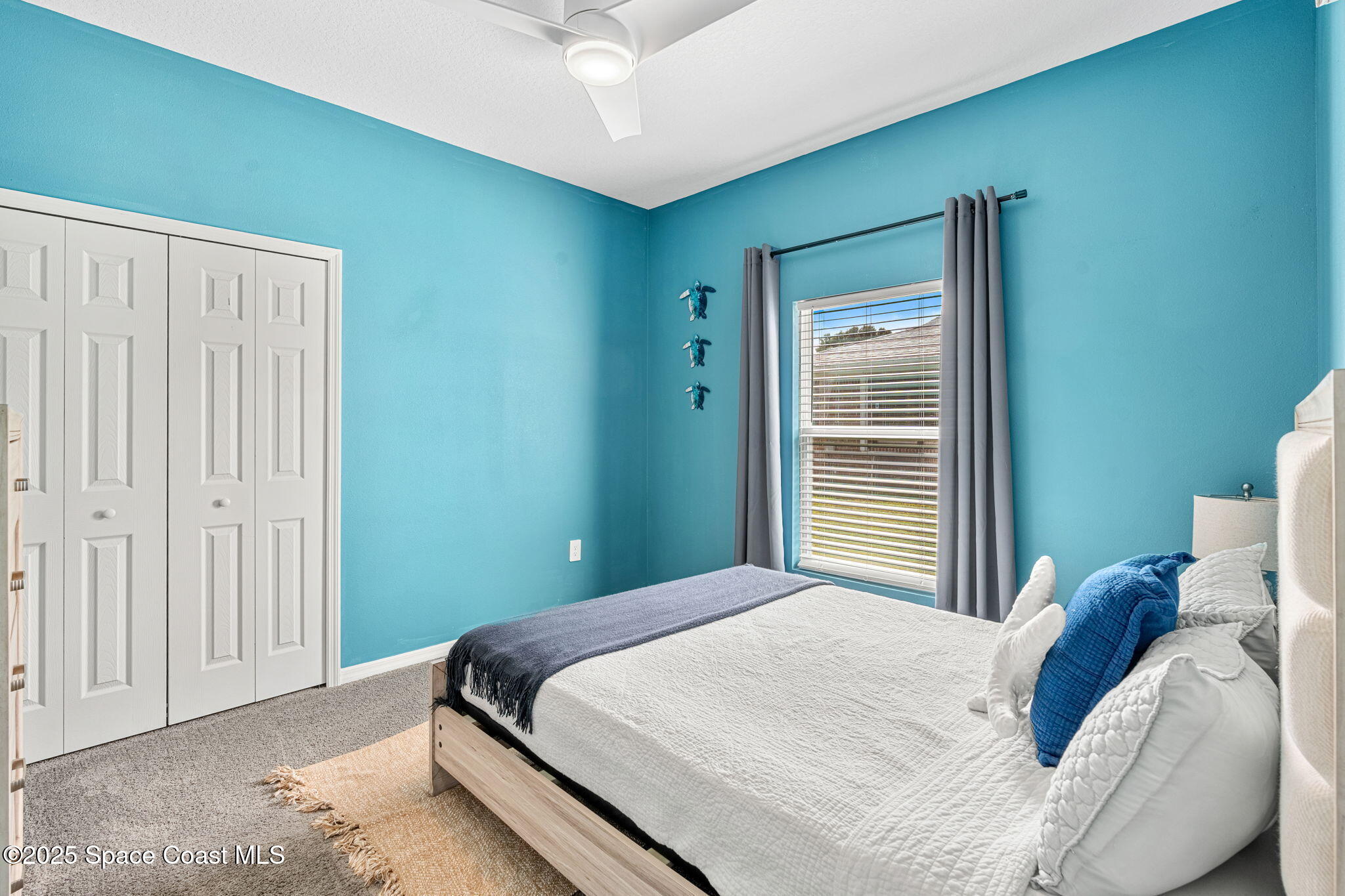 1125 Satin Road Palm Bay, FL 32908 - Photo 18 of 26 a bedroom with a bed and a window