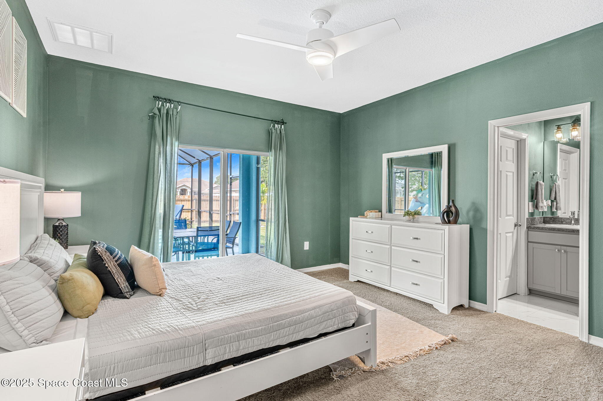 1125 Satin Road Palm Bay, FL 32908 - Photo 19 of 26 a bedroom with a bed and a dresser