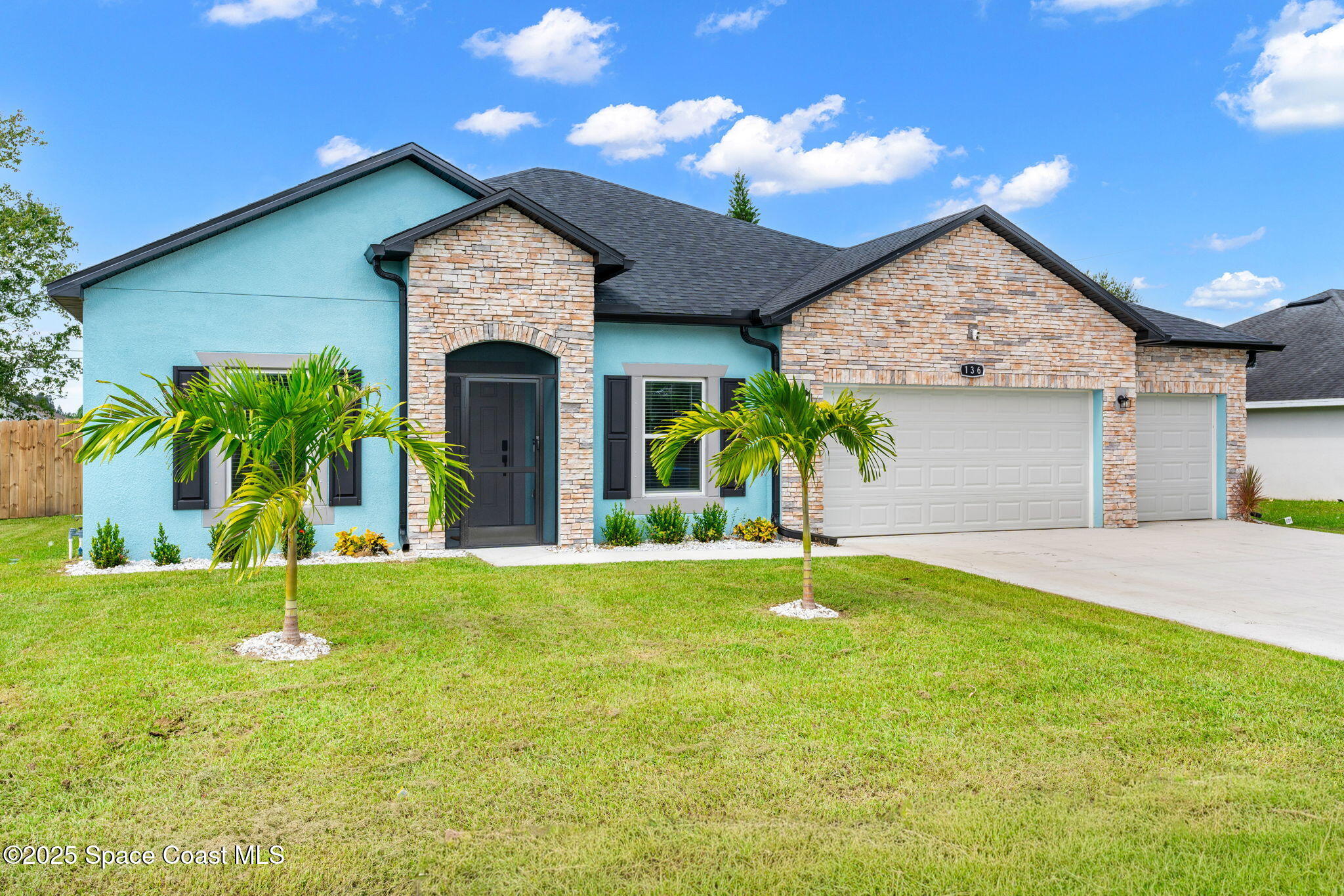 1125 Satin Road Palm Bay, FL 32908 - Photo 2 of 26 a front view of a house with garden