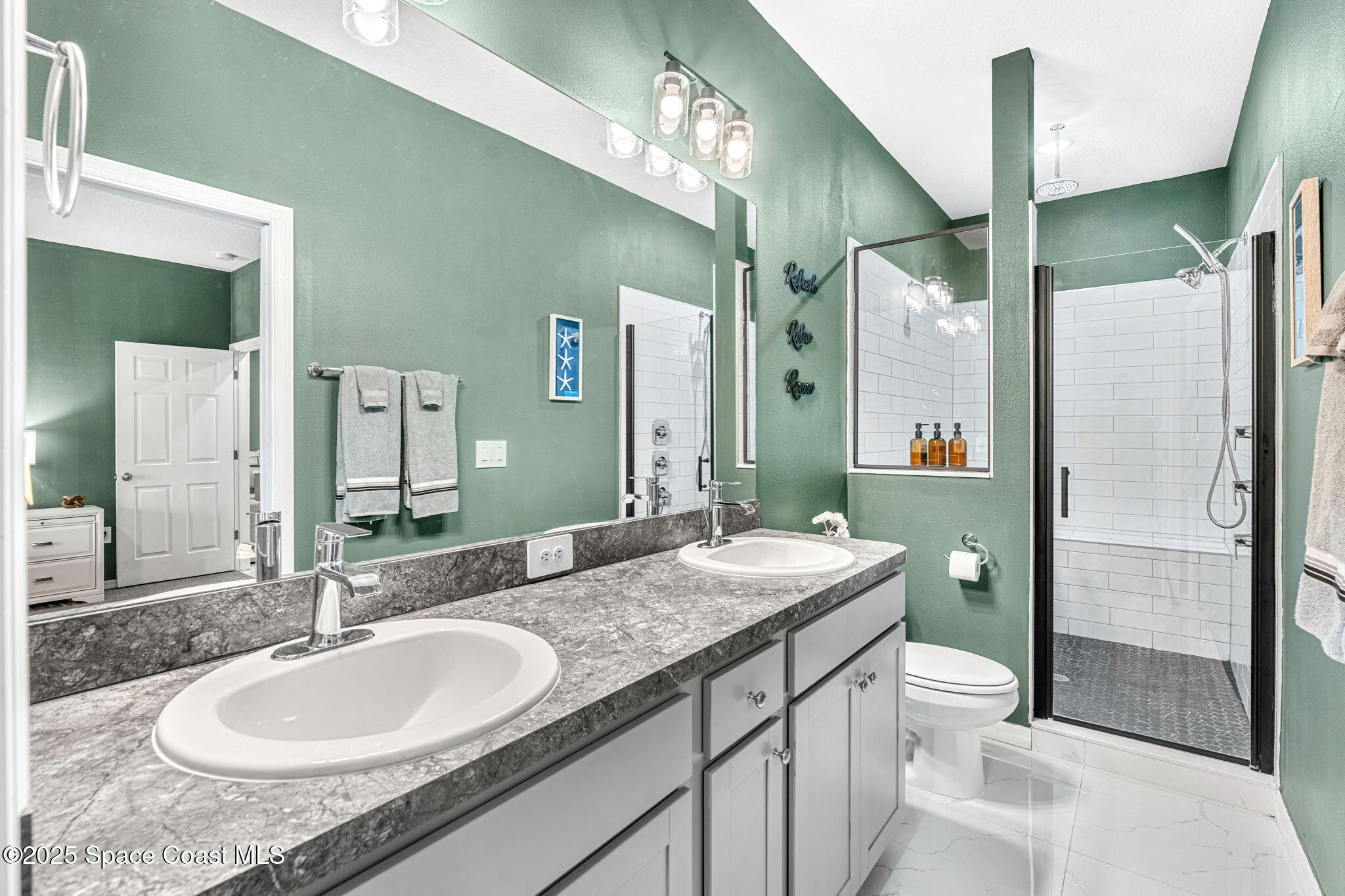 1125 Satin Road Palm Bay, FL 32908 - Photo 21 of 26 a bathroom with a granite countertop double vanity sink toilet and shower