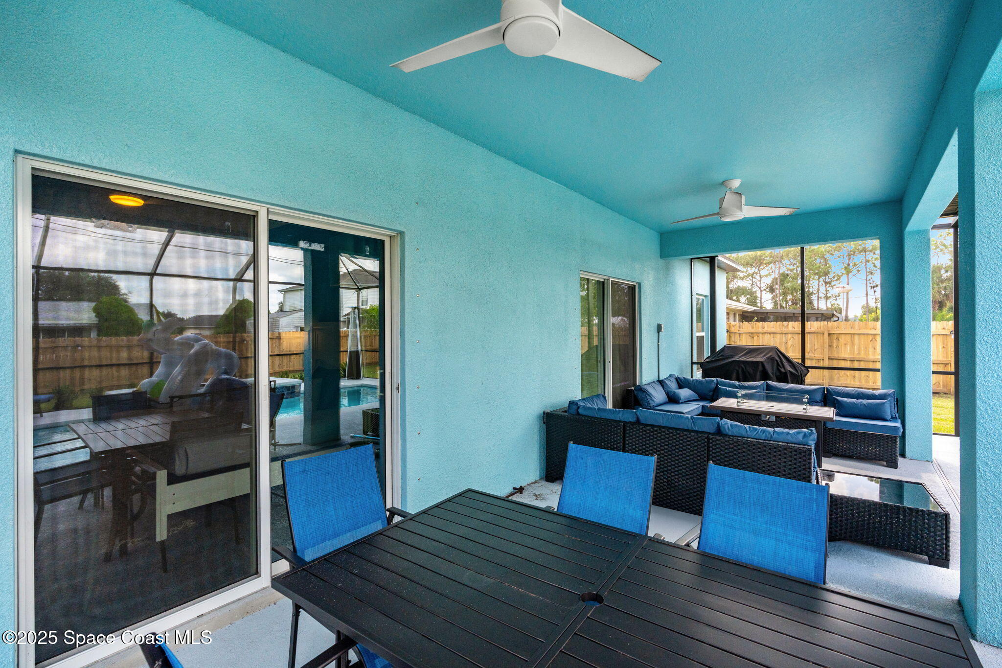 1125 Satin Road Palm Bay, FL 32908 - Photo 24 of 26 a view of a dining room with furniture large windows and wooden floor